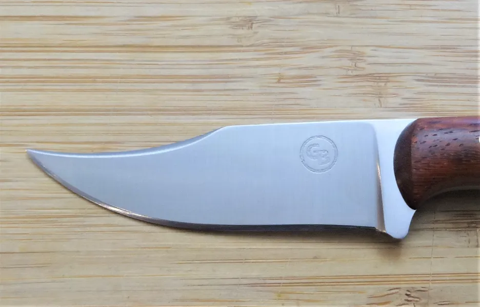 Closeup of right side of blade with 1 1/2" upswept clip point