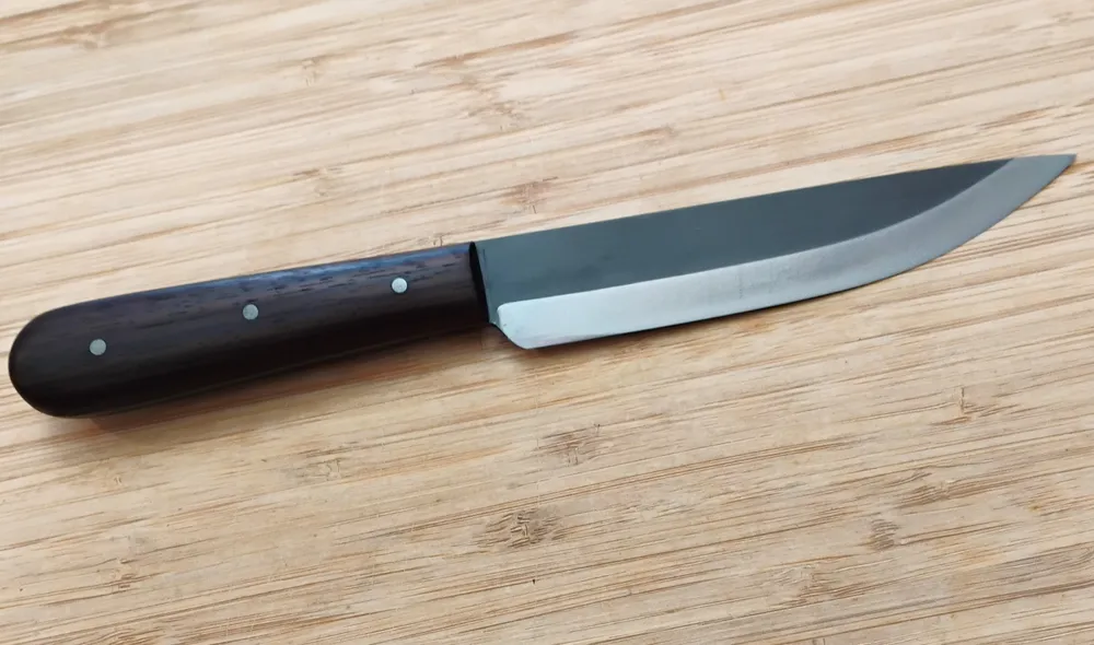 Full Right view of a handcrafted Trade Knife with an East Indian Rosewood handle and a two-tone steel blade.