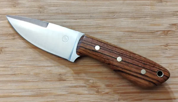 Left full view of 3 Finger Skinner #303 with swedge, thumb serrations and an exotic Zebrawood Handle