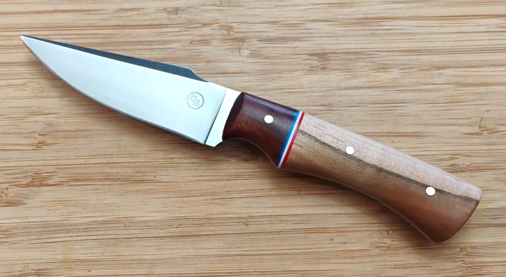 Left view of GreBec 7 5/8" exotic Tulipwood Harpoon Clip Point #283 EDC knife, with a Mopani bolster, 1095 steel blade