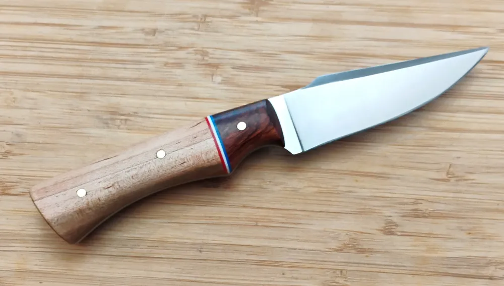 Right view of GreBec Tulipwood Harpoon Clip Point #283 knife, with a Mopani bolster, 1095 steel blade.