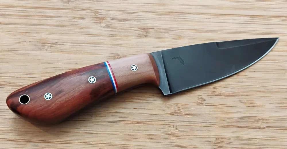 Full right view of a handcrafted knife with stabilized wood handle and darkened blade, one of GreBec Knives custom EDC knives.