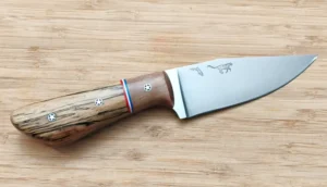 Clip Point Goldilocks 8 1/8” custom knife, right side, showing 1095 steel blade and black olive wood bolster