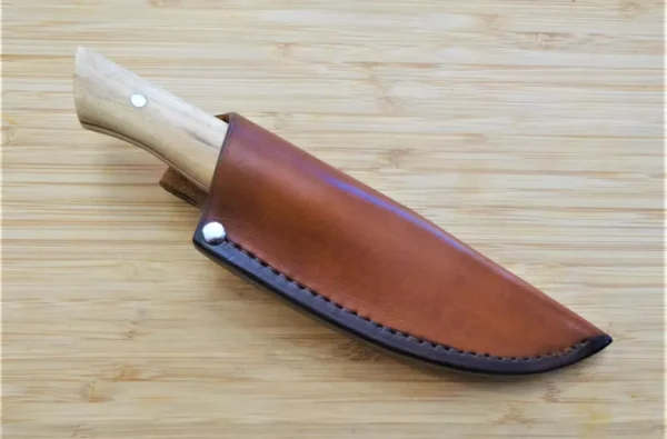 Fixed blade Palatka Holly Harpoon Clip Point #211 custom 1095 high carbons steel blade in a custom, 2 toned leather sheath showcasing the light wood handle