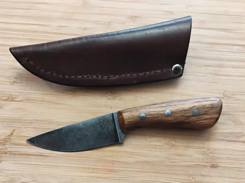 Full left view of drop point knife and custom sheath with belt clip sheath