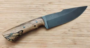 Large Spalted Pecan custom knife showing figured wood and darkened harpoon clip point blade