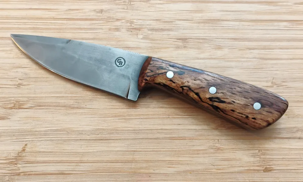 Full left view of a handcrafted Drop Point EDC/Hunter knife with an Antiqued finish on a 1095 high carbon steel blade.