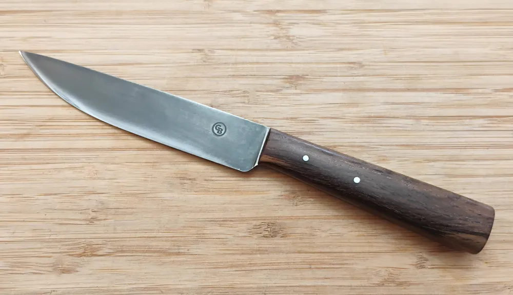 Live Oak French Trade Knife #361 left side view with mild steel pins on a wooden backgound