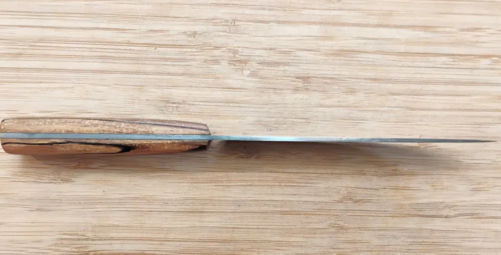 Spine view of an English Trade Knife #365, showcasing a 3/32" 1095 high carbon steel blade with a distal taper.