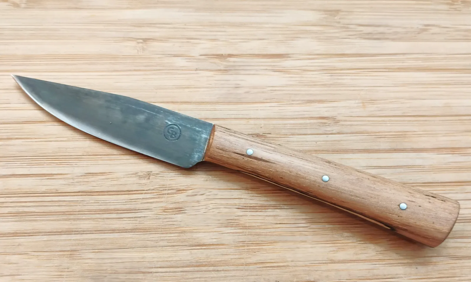 Pecan Tiny Trade Knife full left view, featuring a clip-point blade and Pecan handle, perfect for culinary and outdoor tasks.