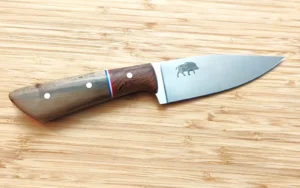 Big Camper #402 hunting knife with wild boar etched clip point blade, FL stabilized Pignut Hickory and Live Oak scales with patriotic G10 accents