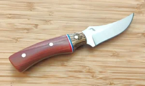 Right side of Red Cedar Trailing Point knife by GreBec Knives, 1095 high-carbon steel blade and stabilized wood handle