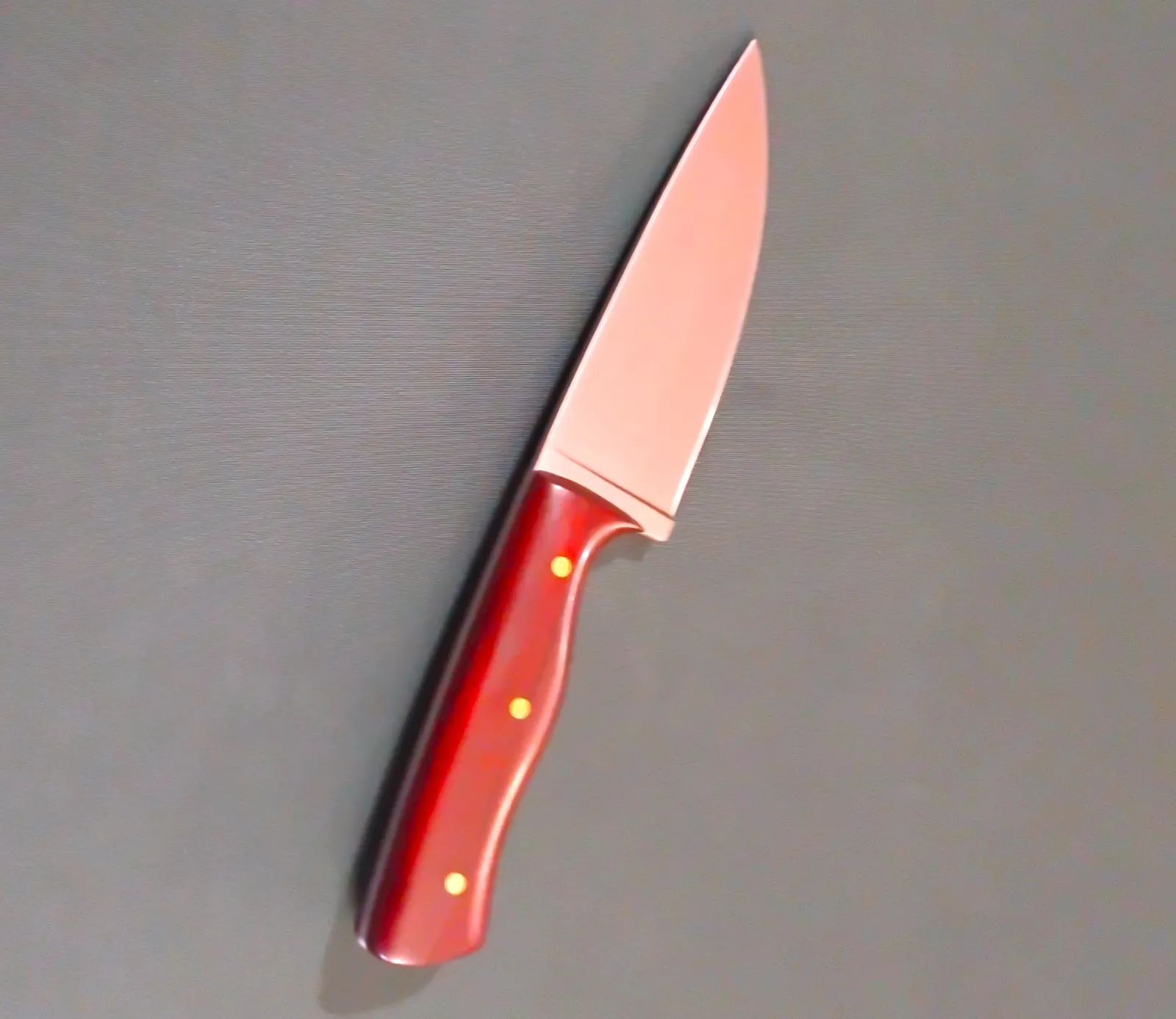 A custom made camp knife, with a unique cocobolo handle and brushed bladed. Made by GreBec Knifes.