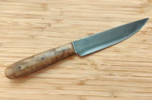Right-side view of a GreBec Knives handmade French trade knife with a Florida-grown Dunstan Chestnut handle and antiqued 1095 high carbon steel blade.