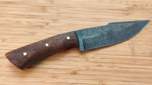 Stonewashed harpoon clip point camp knife handcrafted from 1095 steel with stabilized Florida Royal Poinciana scales