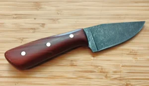 Right side view of the handcrafted Florida Red Cedar Little Skinner hunting knife featuring brass pins and a stonewashed blade.