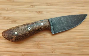 Right side view of the handcrafted Florida Bur Oak 3 Finger Skinner hunting knife featuring mosaic pins and a stonewashed blade.