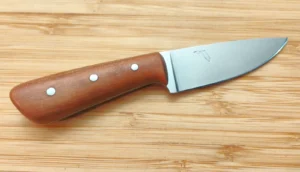 Right side view of Wild Black Cherry Neck Knife #454 highlighting the full blade profile, Florida outline etch, and warm-toned stabilized wood handle.