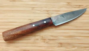 Right side view of Pecan Tiny Trade Knife #456 displaying the full profile of the antiqued clip point blade and dramatic grain in the dark branch-junction Pecan handle.