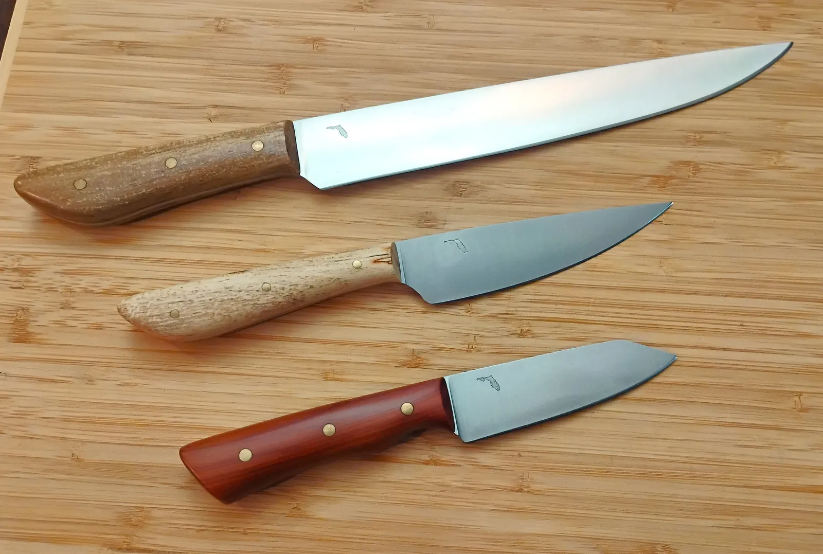 Custom made chef knife and two paring knives from high carbon steel and stabilized Florida wood handles.