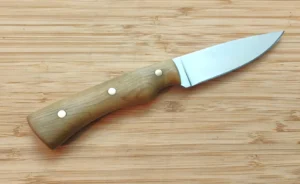 Reverse side of the Southern Magnolia Bird & Trout #472 showing the wood grain and three brass handle pins.