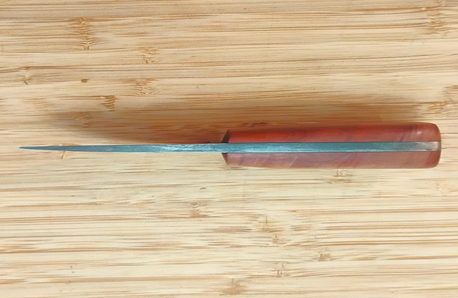 Spine view of the Red Cedar 3 Finger Skinner #473 showing the tapered blade and full-tang construction.